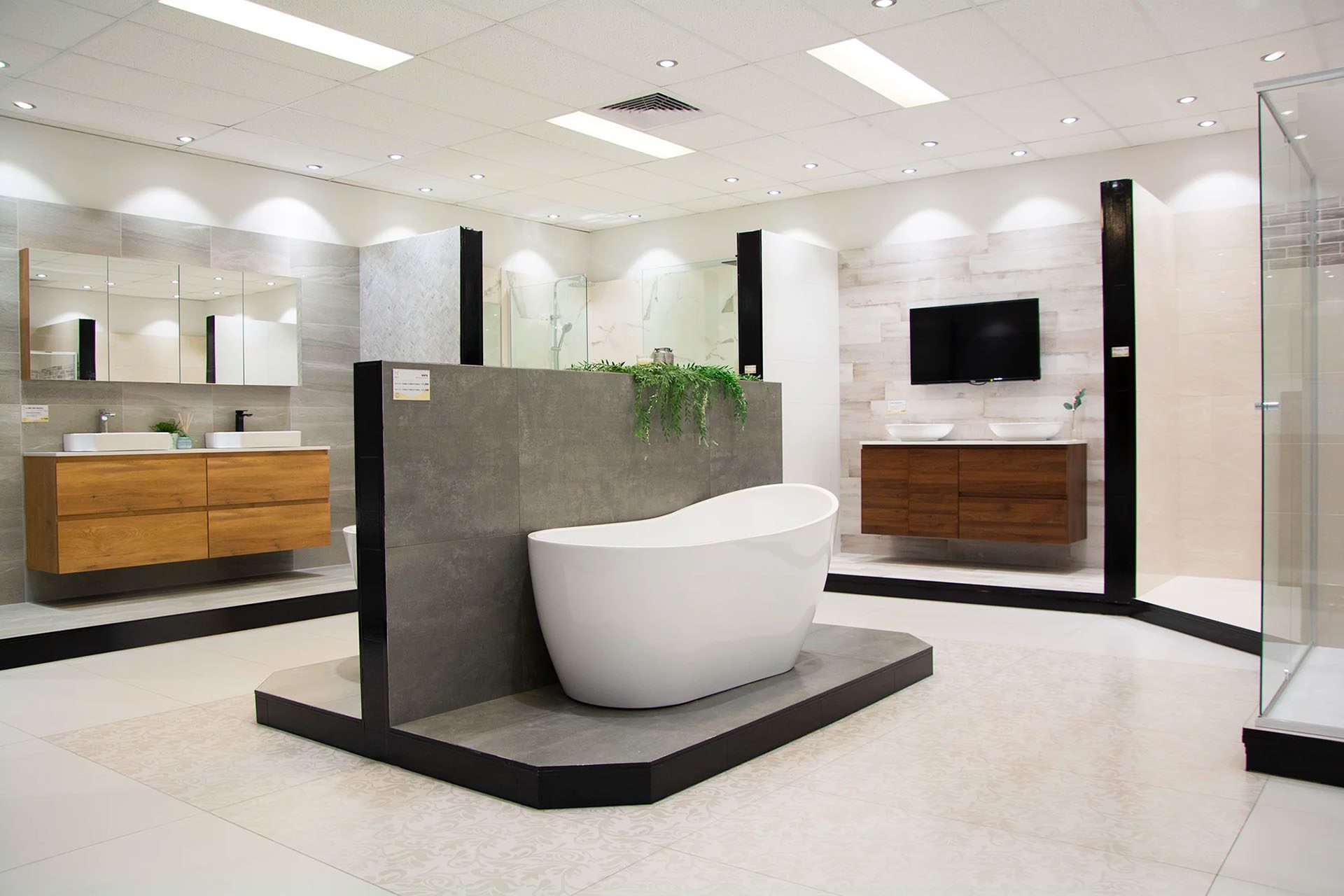 A bath in situ in the showroom against a tiled wall