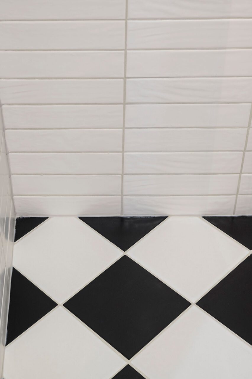 Art Deco Bathroom With Black Tapware and Gold Patterned Wallpaper