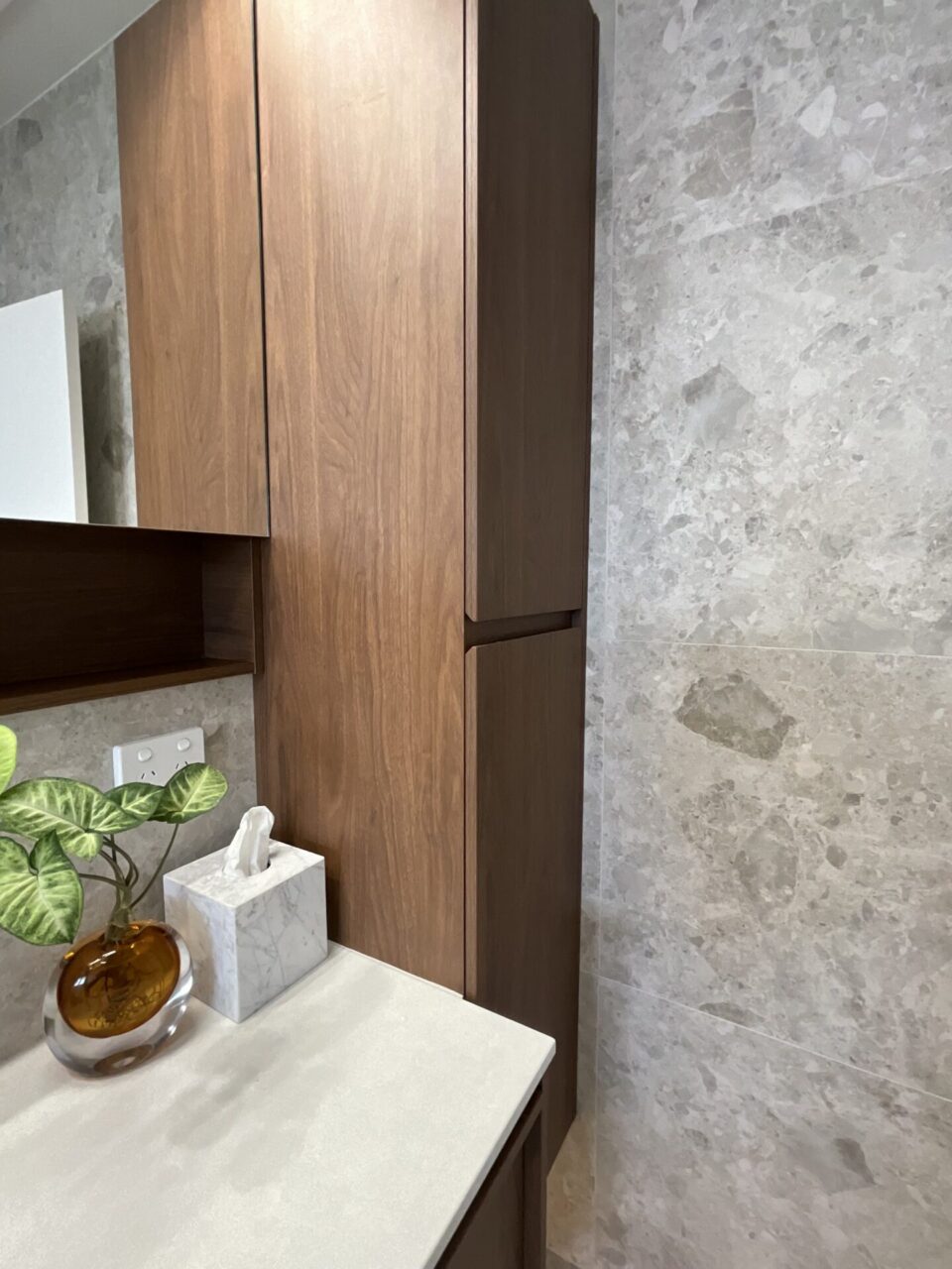 Custom timber tallboy storage cabinet beside vanity in a luxury bathroom renovation